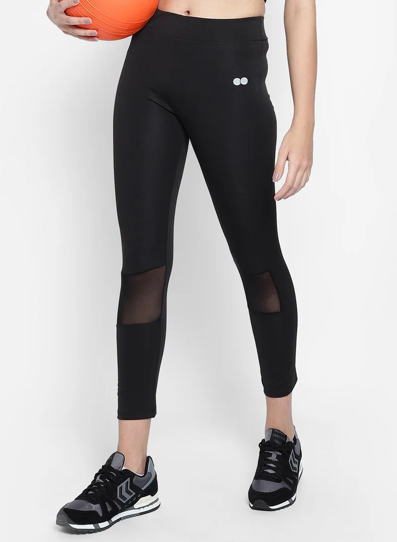 Clovia Black Snug Fit Active Tights in Black with Reflective Logo for Women | Best Price UAE